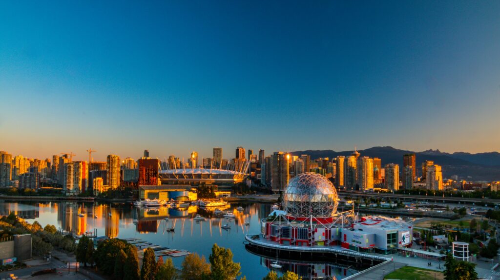 pexels-photo-2382868-2382868 Vibrant sunset view of Vancouver's skyline, featuring Science World and cityscape reflections.