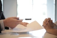 pexels-photo-3760067-3760067-1 Close-up of a contract signing with hands over documents. Professional business interaction.